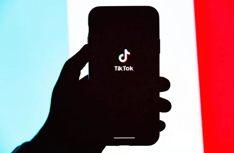 Foto de uma mão segurando um smartphone com o logotipo do TikTok no centro, sendo utilizada para representar a notícia de que o TikTok pode ser banido dos EUA (Estados Unidos)